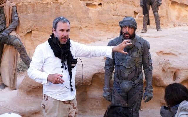 This image released by Warner Bros Pictures shows director Denis Villeneuve, left, and actor Javier Bardem on the set of Dune. AP