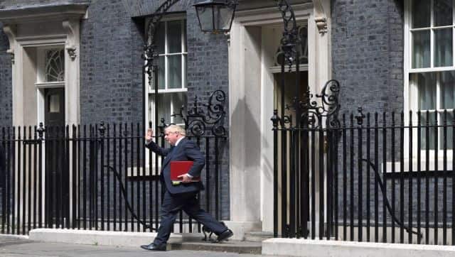 Britain's Prime Minister Boris Johnson leaves from 10 Downing Street in central London. The prime minister has been left on the backfoot after the flood of resignations from his government. AFP
