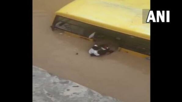 Watch: Locals rescue 30 students from school bus partially submerged in flooded street in Telangana