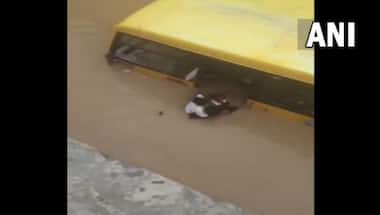 Watch: Locals rescue 30 students from school bus partially submerged in flooded street in Telangana