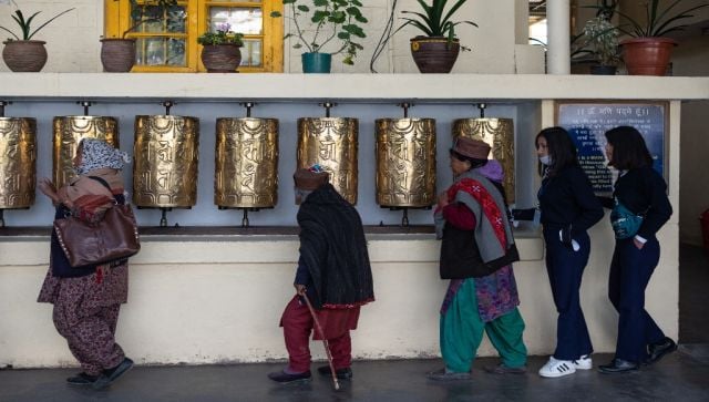 Visitors spin Tibetan prayer wheels at the Dalai Lama Temple complex in McLeod Ganj in Himachal Pradesh. AFP 