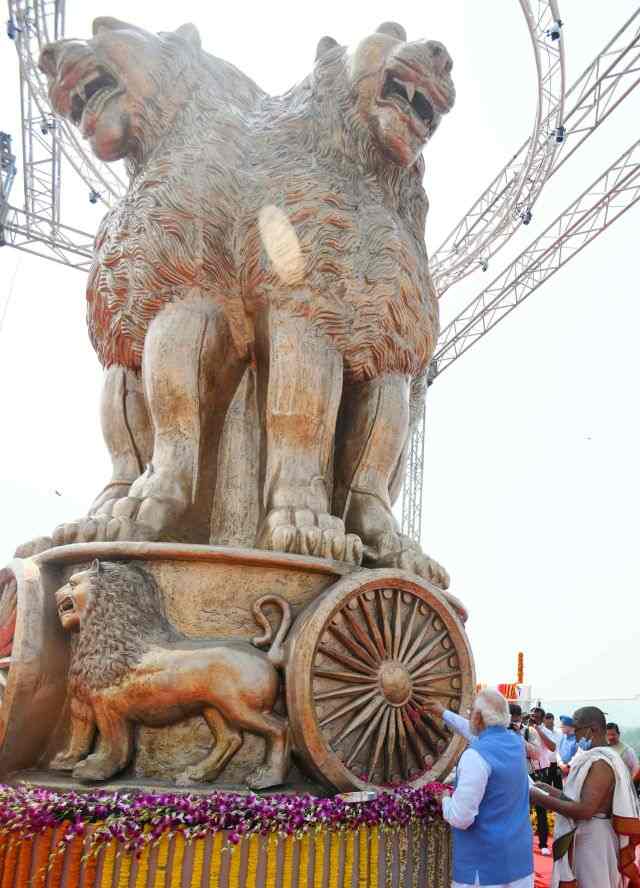Prime Minister Narendra Modi unveiling the 9,500 kg bronze cast of the national emblem atop the new Parliament building. PIB
