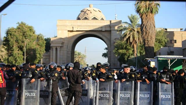 Iraqi security forces stand guard outside the heavily fortified Green Zone during protests in Baghdad. AP 