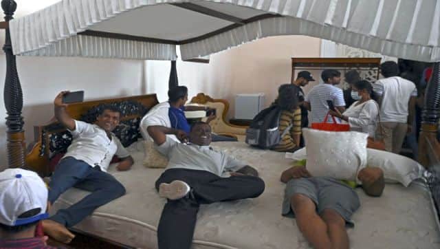 People rest on a massive four-poster bed inside the presidential palace in Colombo, Sri Lanka. AFP