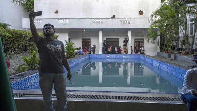 A man takes selfie at the swimmimg pool of the official residence of President Gotabaya Rajapaksa three days after it was stormed by anti-government protesters in Colombo. AP