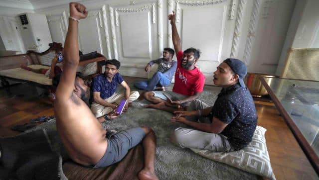 Protesters play cards in the prime minister's official residence a day after it was stormed in Colombo, Sri Lanka. AP