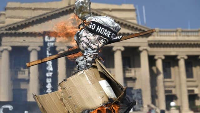 Demonstrators burn an effigy of Ranil Wickremesinghe during a protest in front of Presidential Secretariat in Colombo. AFP