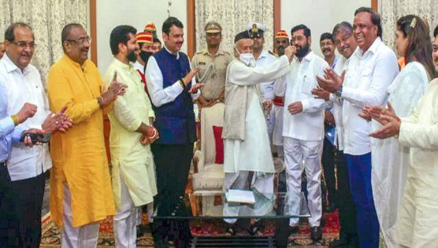  Maharashtra governor Bhagat Singh Koshyari offers sweets to rebel Eknath Shinde as he along with BJP leaders and other supporting MLAs meets the former regarding formation of the government at the state, in Mumbai. PTI