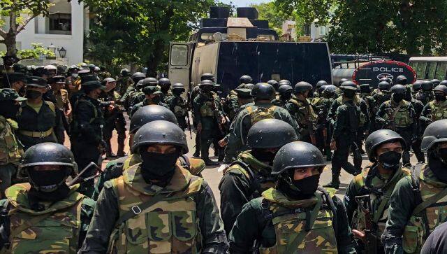 Army soldiers stand guard during an anti-government protest by demonstrators outside the office of Sri Lanka's prime minister in Colombo. AFP 