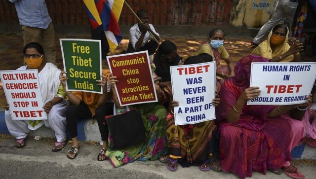 Activists hold placards during a protest against the Chinese invasion in Tibet next to the Chinese consulate in Kolkata. AFP 