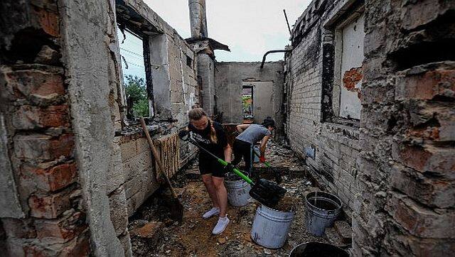 Volunteers clear the rubble of a house destroyed as a result of the shelling in the city of Chernihiv. AFP