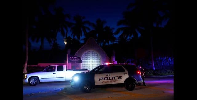 FBI agents and Former President Donald Trump’s supporters in front of his home Mar-a-Lago. AP