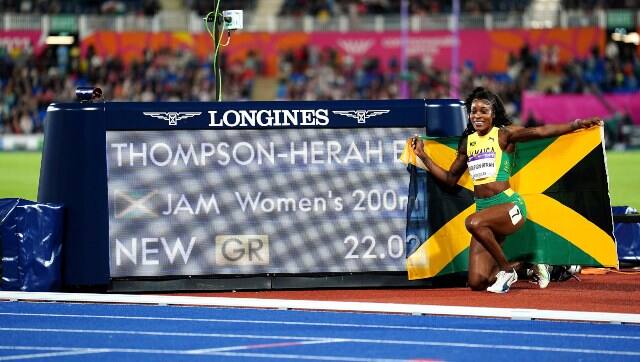 Jamaica's Elaine Thompson-Herah celebrates winning gold in the Women's 200m Final on day nine of the 2022 Commonwealth Games in Birmingham, England, Saturday Aug. 6, 2022. (Martin Rickett/PA via AP)
