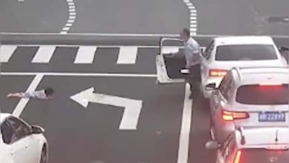 Watch: Child falls out of car's window on busy road in China, motorists rush to rescue
