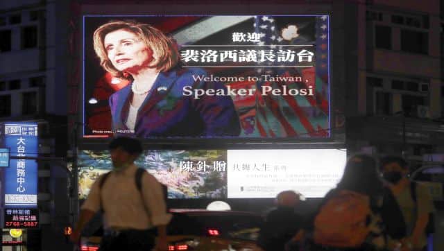 People walk past a billboard welcoming US House Speaker Nancy Pelosi, in Taipei, Taiwan. AP
