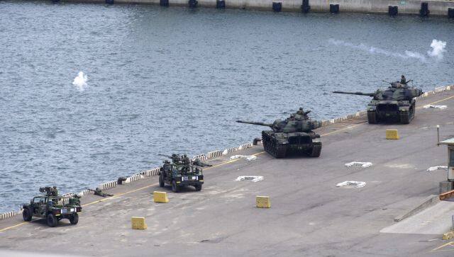 In this photo released by the Taiwan Ministry of National Defence, Taiwan military forces conduct anti-landing drills during the annual Han Kuang military exercises near New Taipei City in Taiwan on 27 July. Taiwan has put its military on alert as China holds massive drills. AP