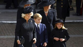 Royal funeral guests wear quiet tributes to the Queen