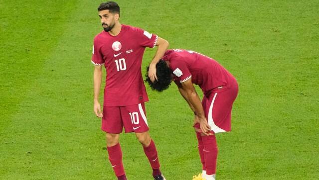Qatar’s Hassan Al-Haydos, left, and Akram Afif reacts after the World Cup group A soccer match between Qatar and Senegal, at the Al Thumama Stadium in Doha, Qatar, Friday, Nov. 25, 2022. Senegal won 3-1. (AP Photo/Ariel Schalit)