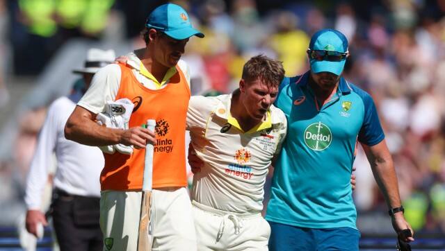 Australia’s David Warner, centre, is assisted from the field as he retires injured after reaching 200 runs during the second cricket test between South Africa and Australia at the Melbourne Cricket Ground, Australia, Tuesday, Dec. 27, 2022. (AP Photo/Asanka Brendon Ratnayake)