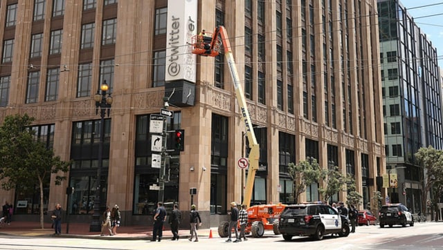 Twitter staff trying to remove the older logo from their building get detained by the police