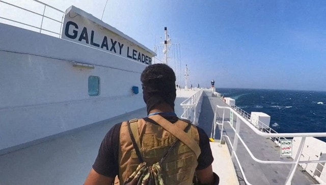 Houthi fighter stands on a cargo ship in the Red Sea. Reuters