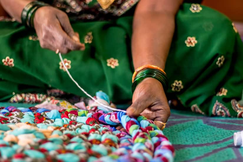 Stitching loops into saris is one of the most tedious parts of making a doormat