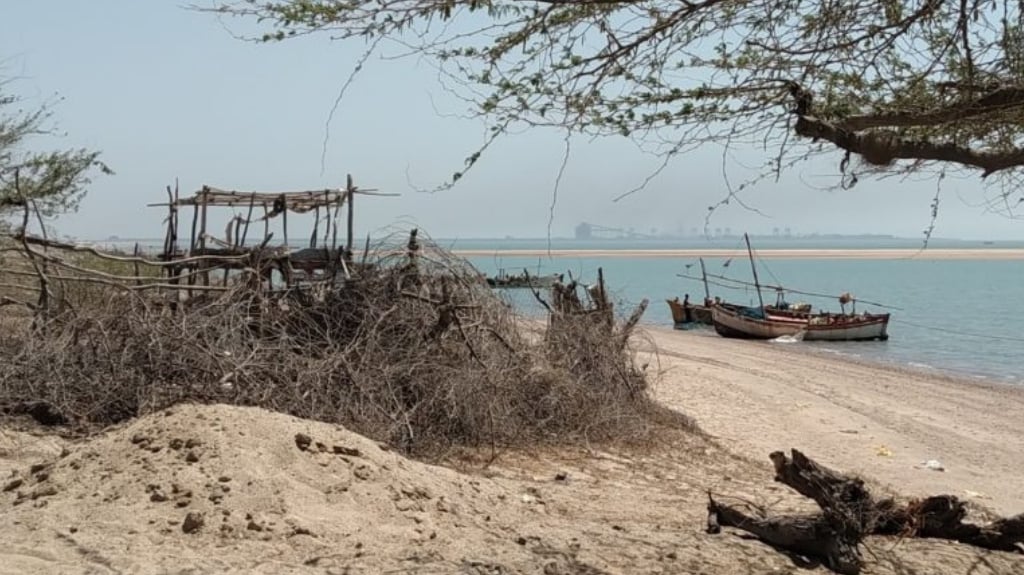 An abandoned fisherman’s settlement (left) near the outfall channel of the power plant in Mundra. Photo by Azera Parveen Rahman.