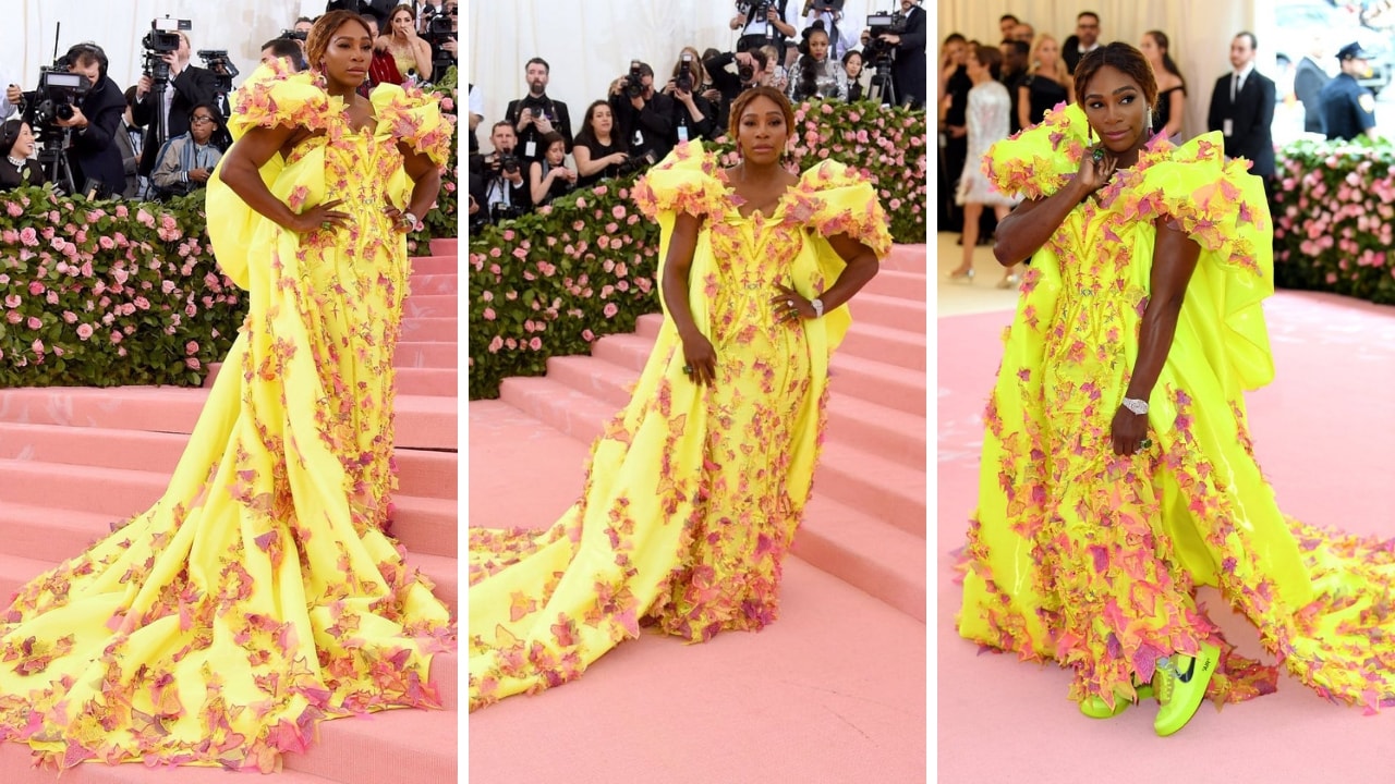 Serena Williams paired designer sneakers with neon yellow strong-shouldered Versace gown with pink feathery and leaf appliqué. Twitter/@MEfeatermagazine