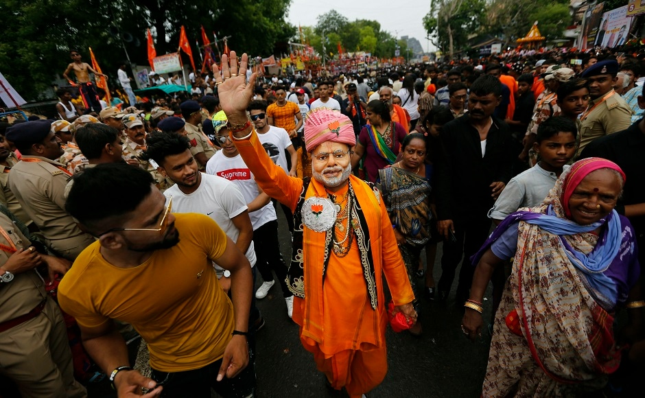 A Hindu devotee (centre) wearing a mask of Narendra Modi, participates in the annual festival of Rath Yatra in Ahmedabad. Prime Minister Narendra Modi also greeted people on the occasion on Twitter. AP A Hindu devotee (centre) wearing a mask of Narendra Modi, participates in the annual festival of Rath Yatra in Ahmedabad. Prime Minister Narendra Modi also greeted people on the occasion on Twitter. AP