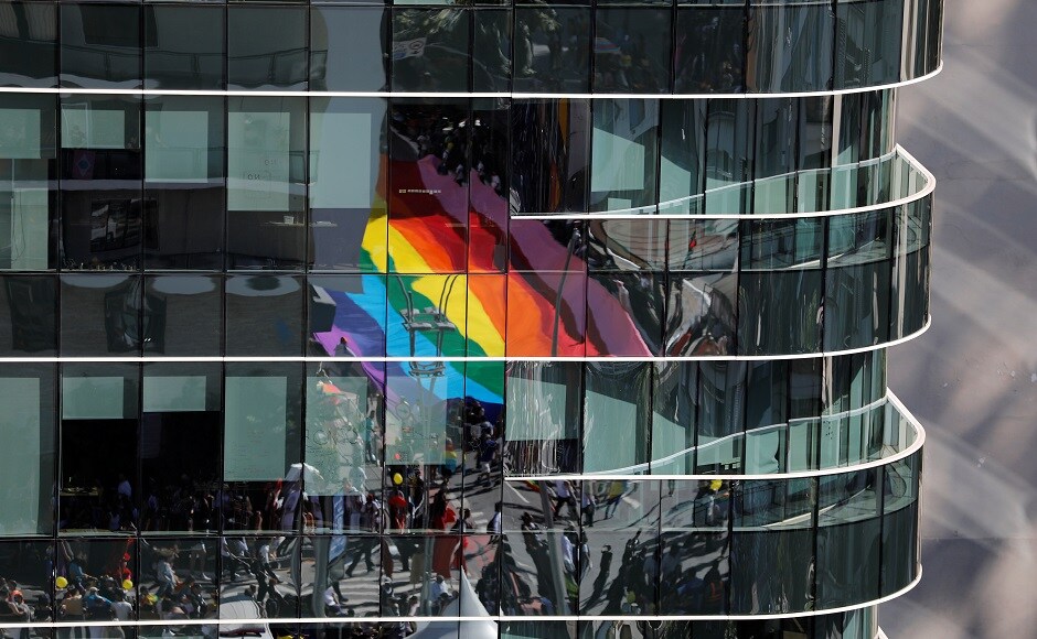 Revellers are seen reflected as they participate in the Gay Pride parade along Paulista Avenue in Sao Paulo, Brazil on 23 June, 2019. Reuters/Nacho Doce Revellers are seen reflected as they participate in the Gay Pride parade along Paulista Avenue in Sao Paulo, Brazil on 23 June, 2019. Reuters/Nacho Doce