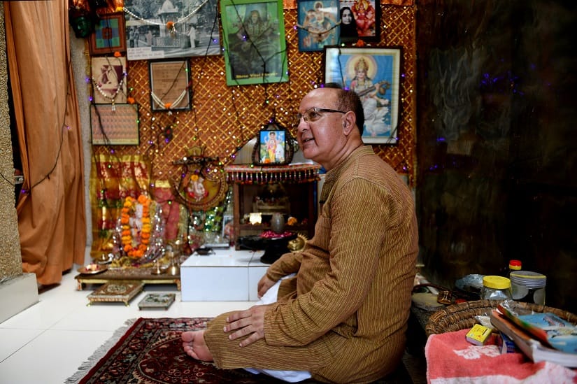 In this photograph taken on 8 August, 2019, Utpal Kaul, historian and Kashmiri Pandit, sits inside a temple at his residence in New Delhi. AFP