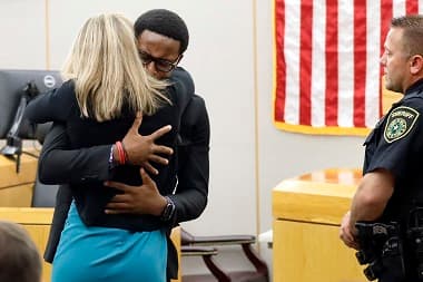Botham Jean’s younger brother Brandt Jean hugs convicted murderer and former Dallas Police Officer Amber Guyger after delivering his impact statement to her after she was sentenced to 10 years in jail. AP