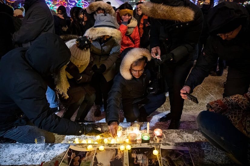 Mourners place candles and photographs at a shrine in Canada. AP