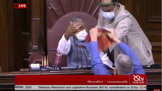In Rajya Sabha, Opposition MPs sloganeer and tear official papers over passage of farm bills In Rajya Sabha, Opposition MPs sloganeer and tear official papers over passage of farm bills