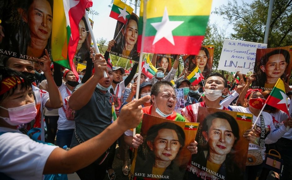 In this 7 March, 2021, file photo, Myanmar nationals living in Thailand hold pictures of deposed Myanmar leader Aung San Suu Kyi as they protest against the military coup in front of the United Nations building in Bangkok, Thailand. (AP Photo/Nava Sangthong)