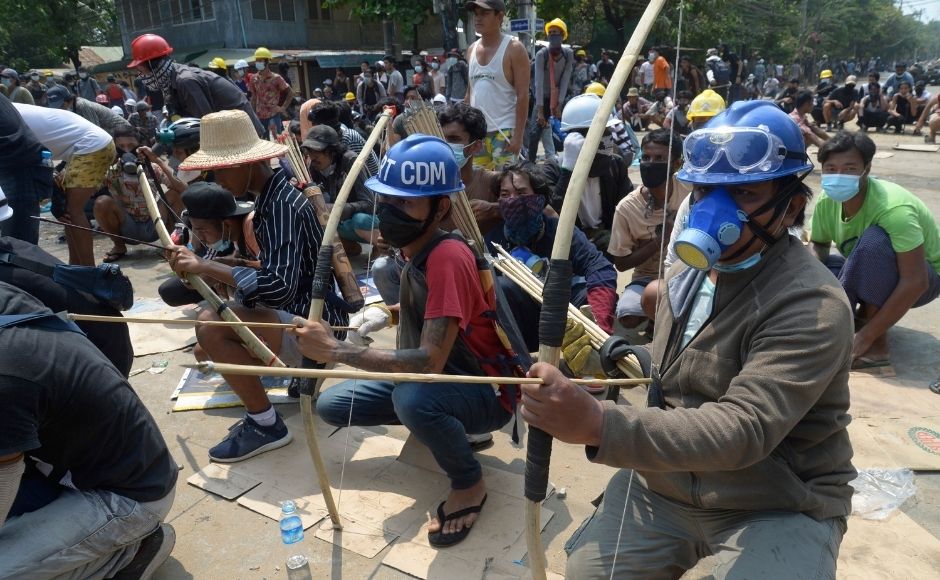 In this 27 March, 2021, file photo, anti-coup protesters prepare makeshift bow and arrows to confront police in Thaketa township Yangon, Myanmar. (AP Photo, File)