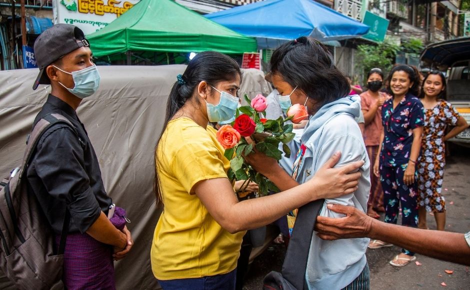 In this 26 March, 2021, file photo, an anti-coup student protester is welcomed home with flowers by the residents of her neighbourhood after being released from jail in Yangon, Myanmar. (AP Photo, File)