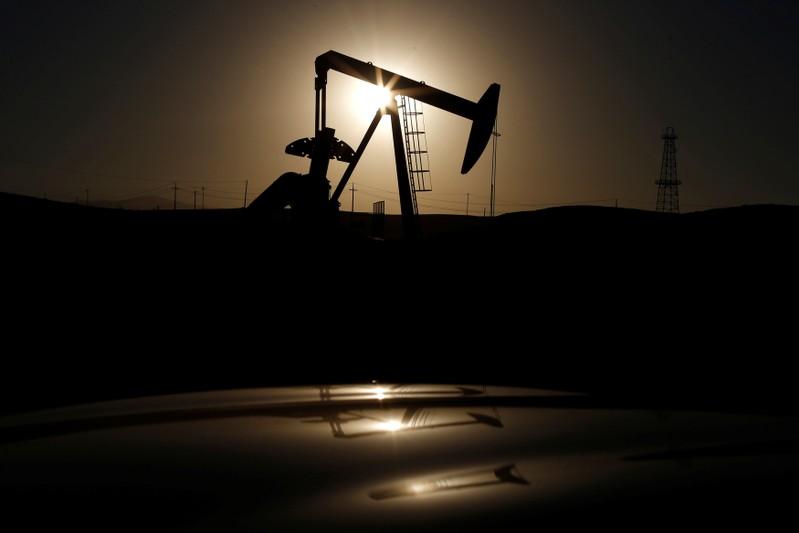 Oil falls weighed by rising US fuel stocks crude output