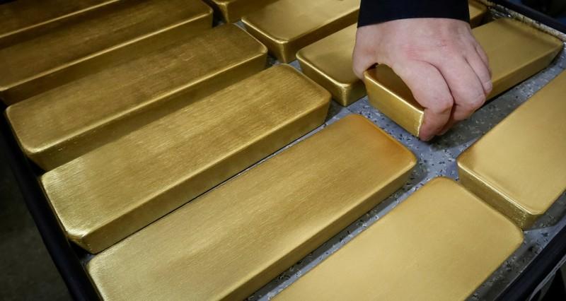 Gold heads for first weekly loss in five as stocks dollar gain