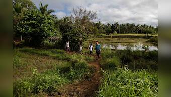 Scaling roofs and mountains, Philippine students battle to take online classes