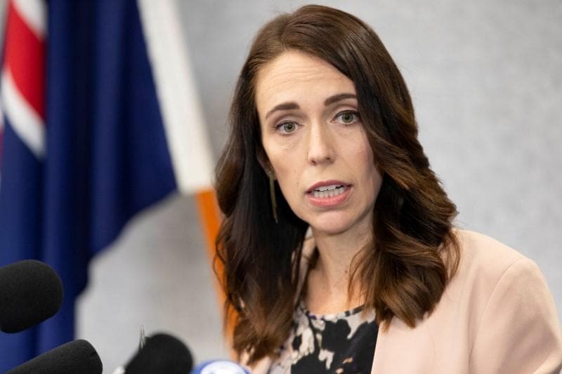 New Zealands Ardern keeps schools open urges limits on movement