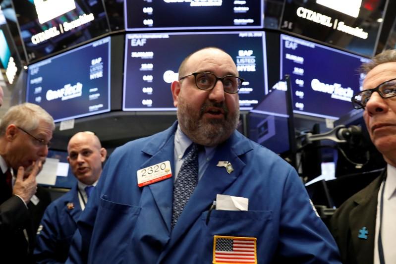 Wall Street tumbles on chip stocks, commodities soften after wild ride