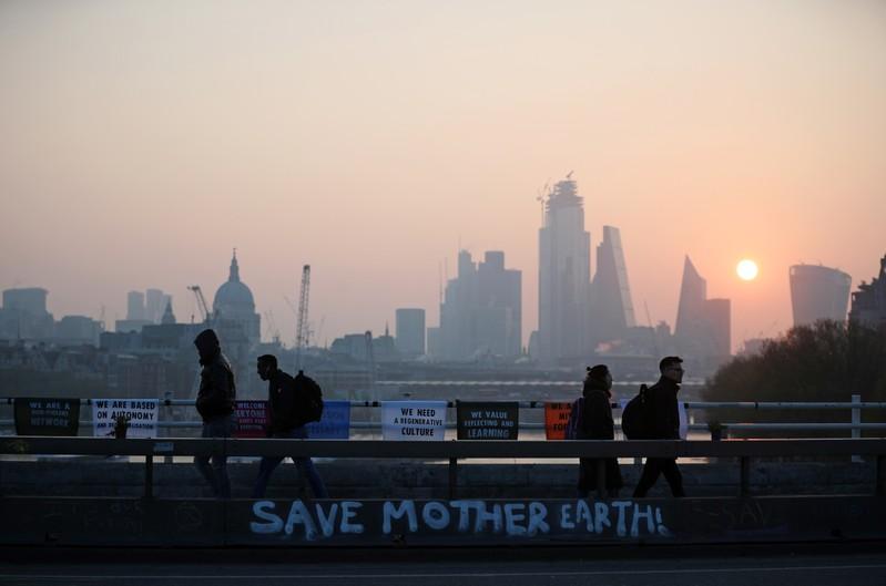 Climate-change protesters disrupt London docklands train service Climate-change protesters disrupt London docklands train service