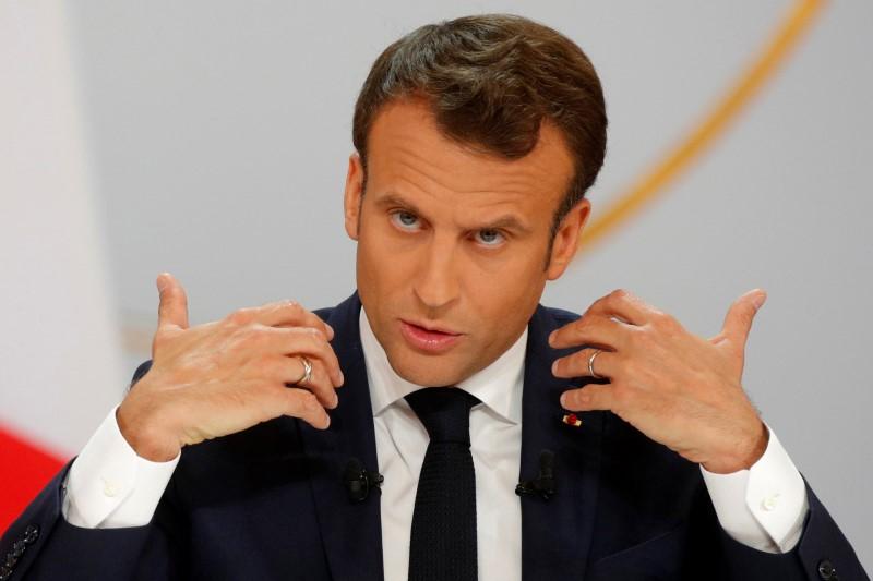 At marathon news conference Macron launches fight back with tax cuts