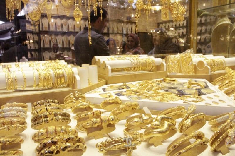 Gold hits 2018 low as trade comments lift stocks dollar