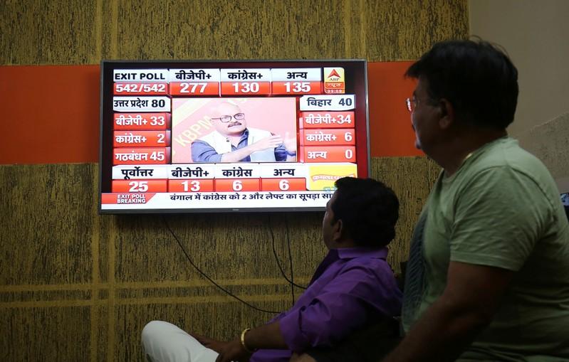 Modi set to return to power with a bigger majority exit polls show