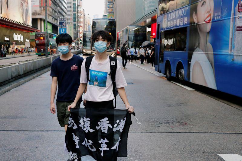 Ignoring social distancing protesters mock Hong Kong leader Lam on her birthday