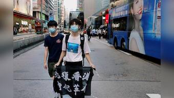 Ignoring social distancing, protesters mock Hong Kong leader Lam on her birthday