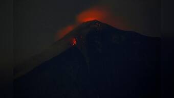 Rescue workers struggle as 'fire' volcano spews hot mud flow