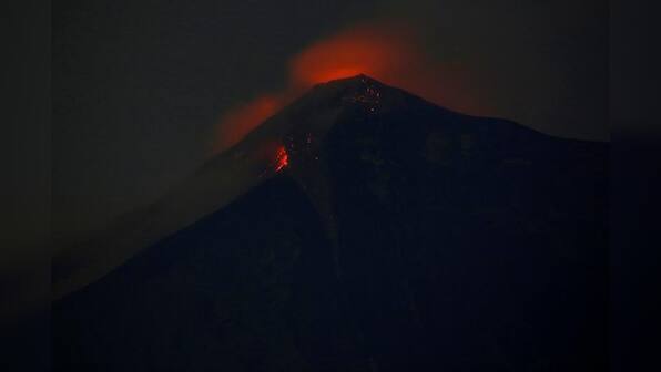 Rescue workers struggle as 'fire' volcano spews hot mud flow